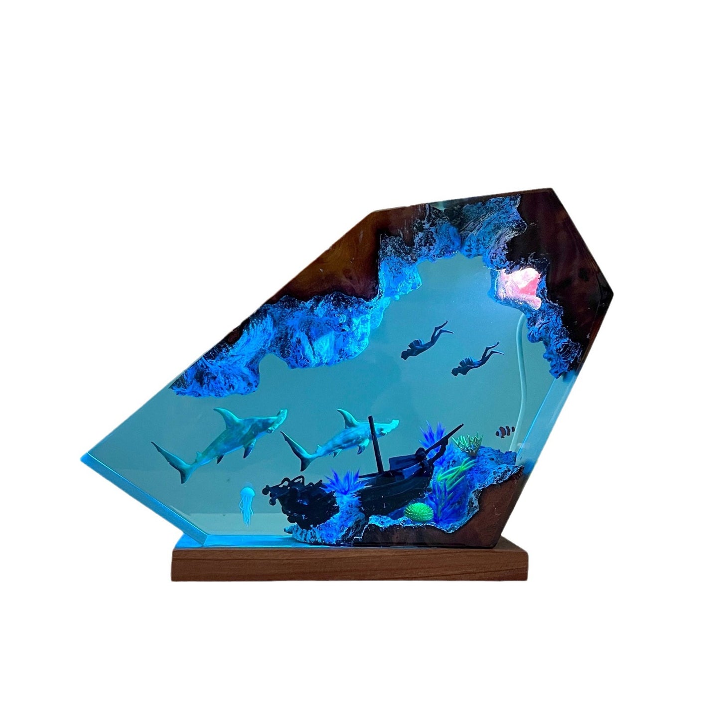 Decorative underwater scene with sharks and a shipwreck inside a wooden frame on a white background
